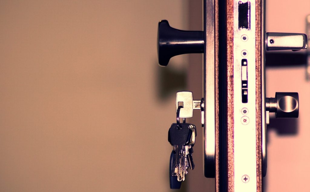 open door with keys hanging in lock